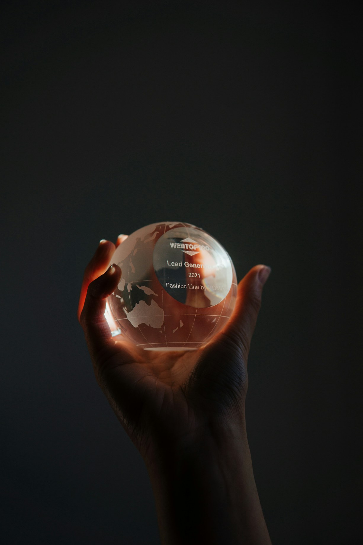 Hand holding glass globe